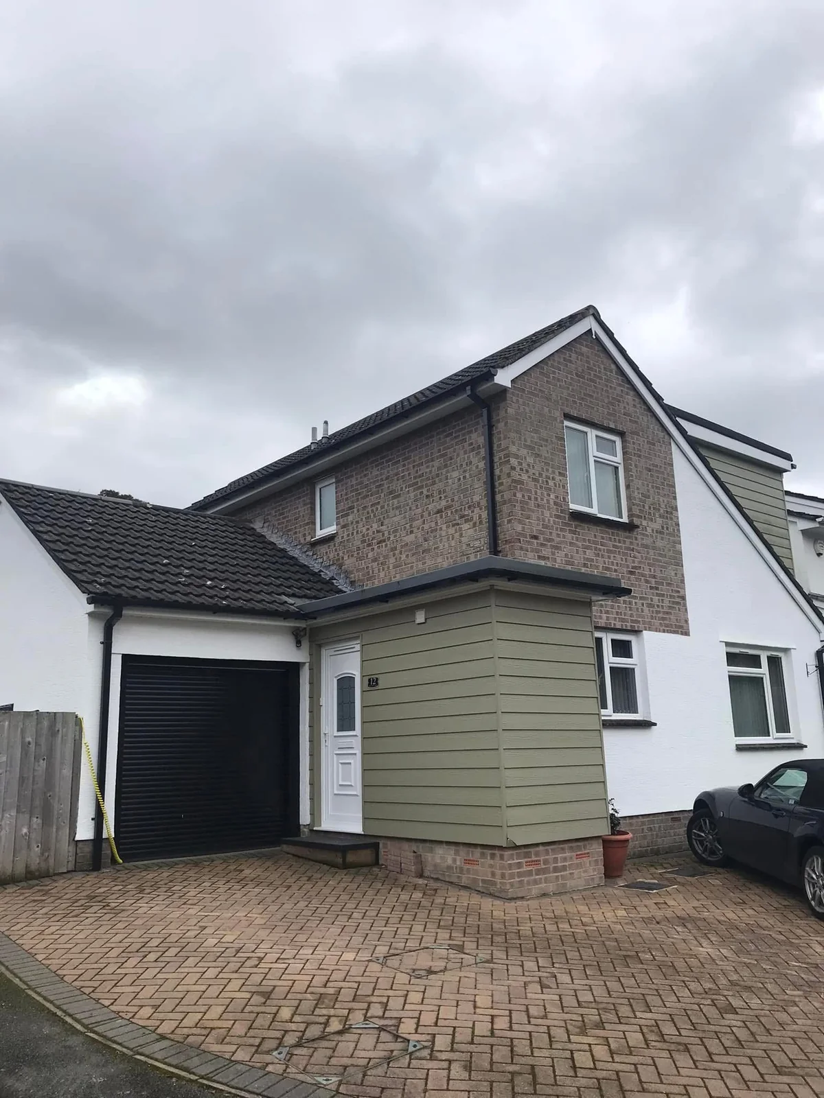 Green cladding and white window on a completed property